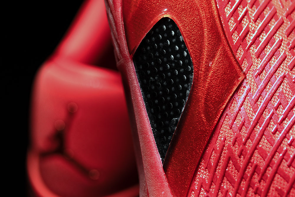 Air Jordan 41 carbon fiber and TPU shank exposed through a cutout in the red lateral sidewall