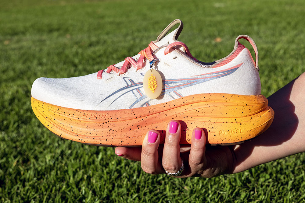 ASICS x FP Movement GEL-Nimbus 28 in Pearled Ivory with a yellow to orange speckled midsole and coral ASICS stripes