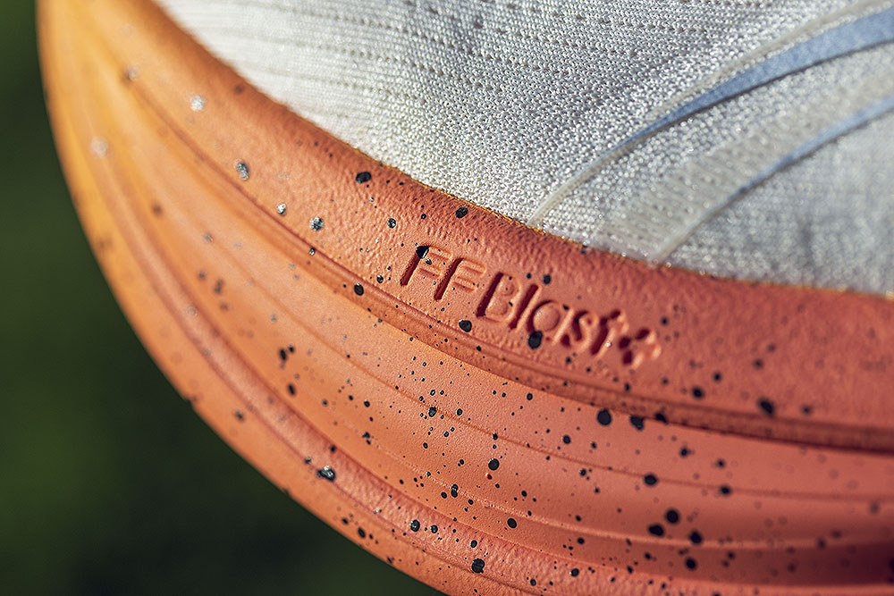FF BLAST+ debossed on the orange speckled midsole of the ASICS x FP Movement GEL-Nimbus 28