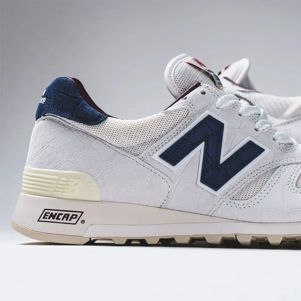 New Balance 1300 Sea Salt pair, Blue Oyster and Mulled Wine accents on an off-white upper