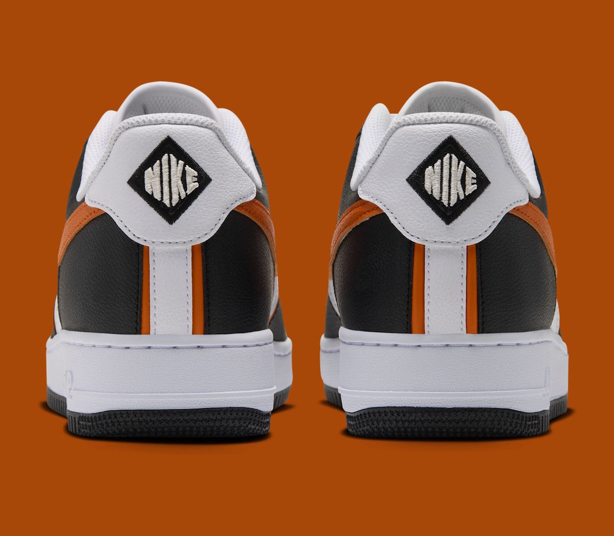 Heel view of the Nike Air Force 1 Low Campfire Orange showing the white tab with a black diamond Nike wordmark in place of Nike Air embroidery