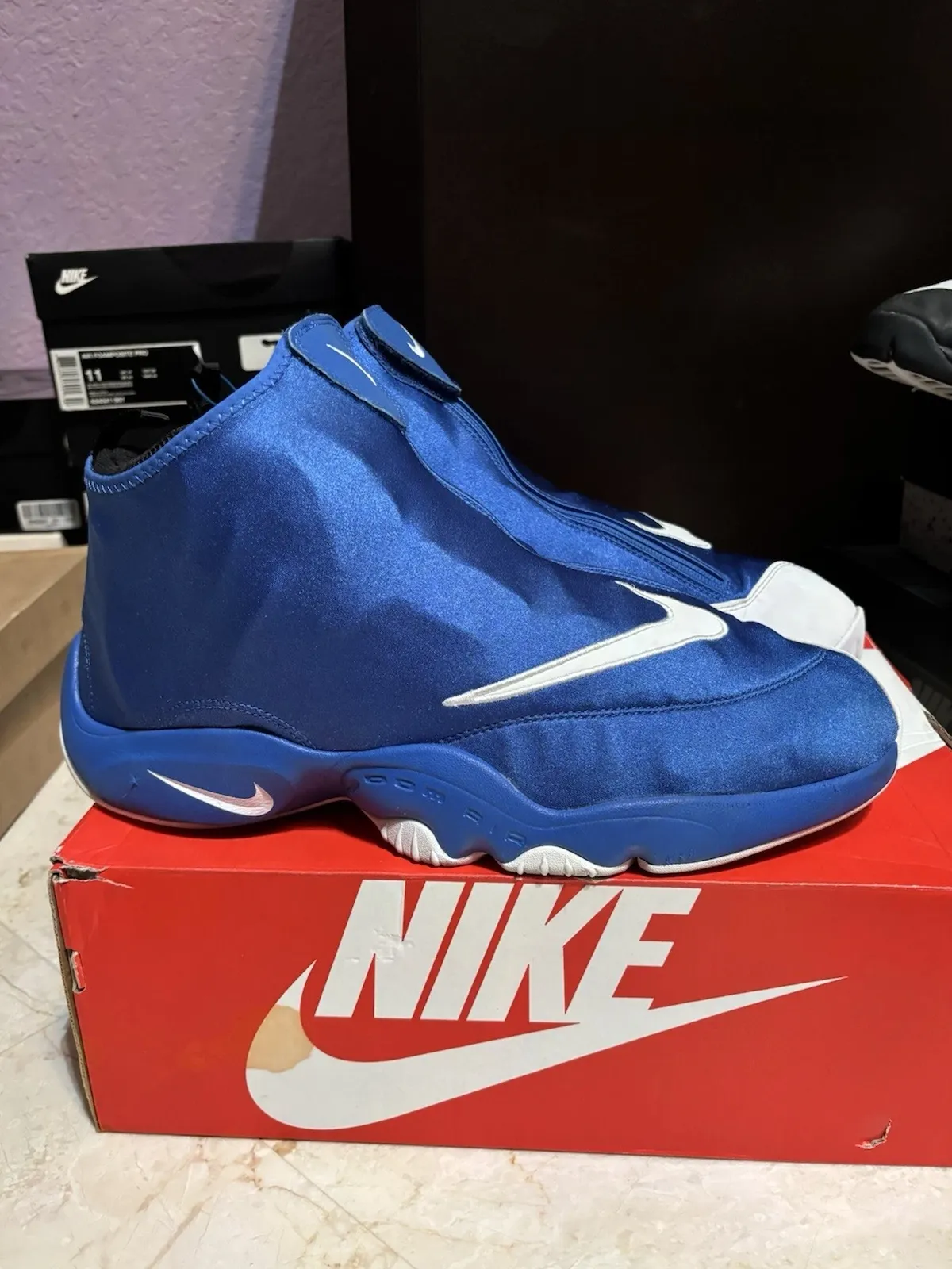Lateral view of the Nike Air Zoom Flight The Glove in royal blue with a white Swoosh curving across the toe