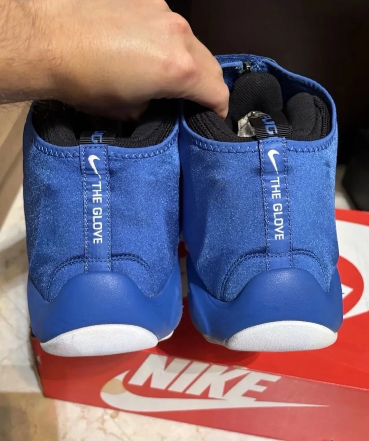 Rear view of the Nike Air Zoom Flight The Glove in royal blue showing THE GLOVE branding on both pull tabs