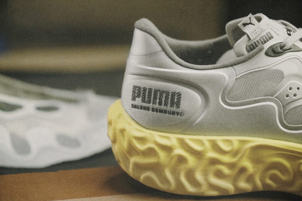 Heel of the PUMA x Salehe Bembury Velum 2 NITRO showing the PUMA and SALEHE BEMBURY branding above the sculpted yellow midsole