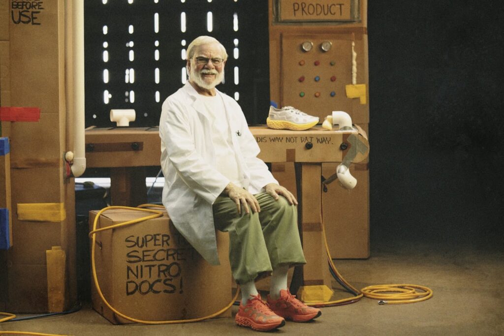 PUMA x Salehe Bembury Velum 2 NITRO in Red Clay worn on foot on the cardboard laboratory campaign set