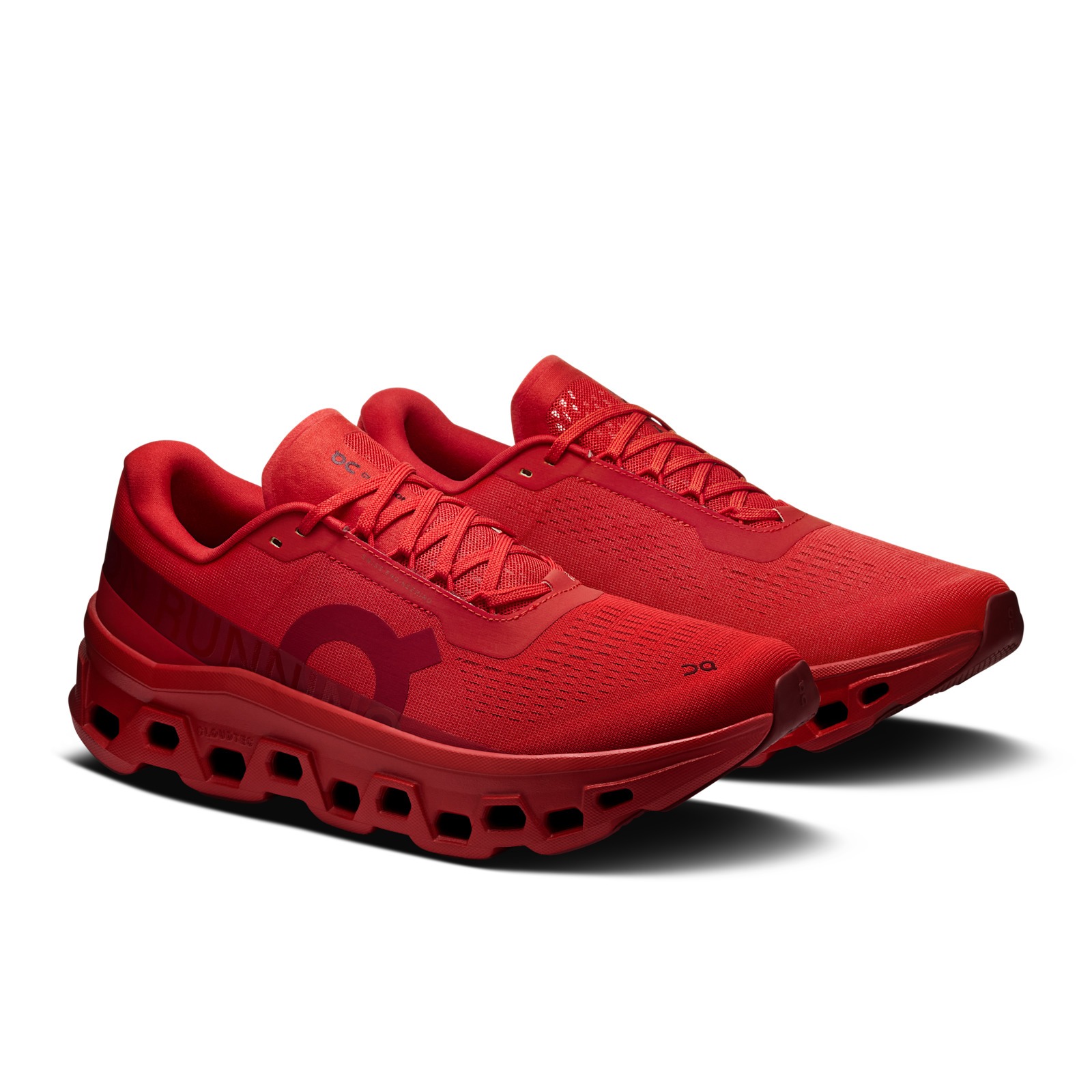 On Cloudmonster BB in tonal Sienna red, pair at an angle